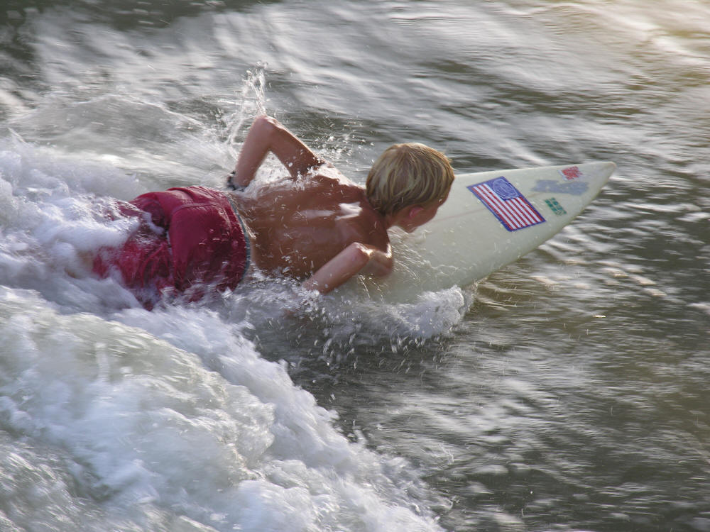 kid surfing, surfer boy on surf board at the beach